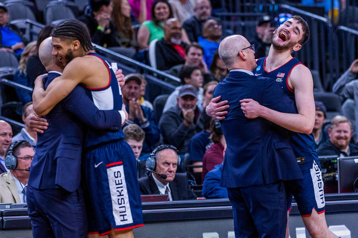 UConn head coach Dan Hurley, right, hugs forward Alex Karaban (11) as guard Andre Jackson Jr. ( ...