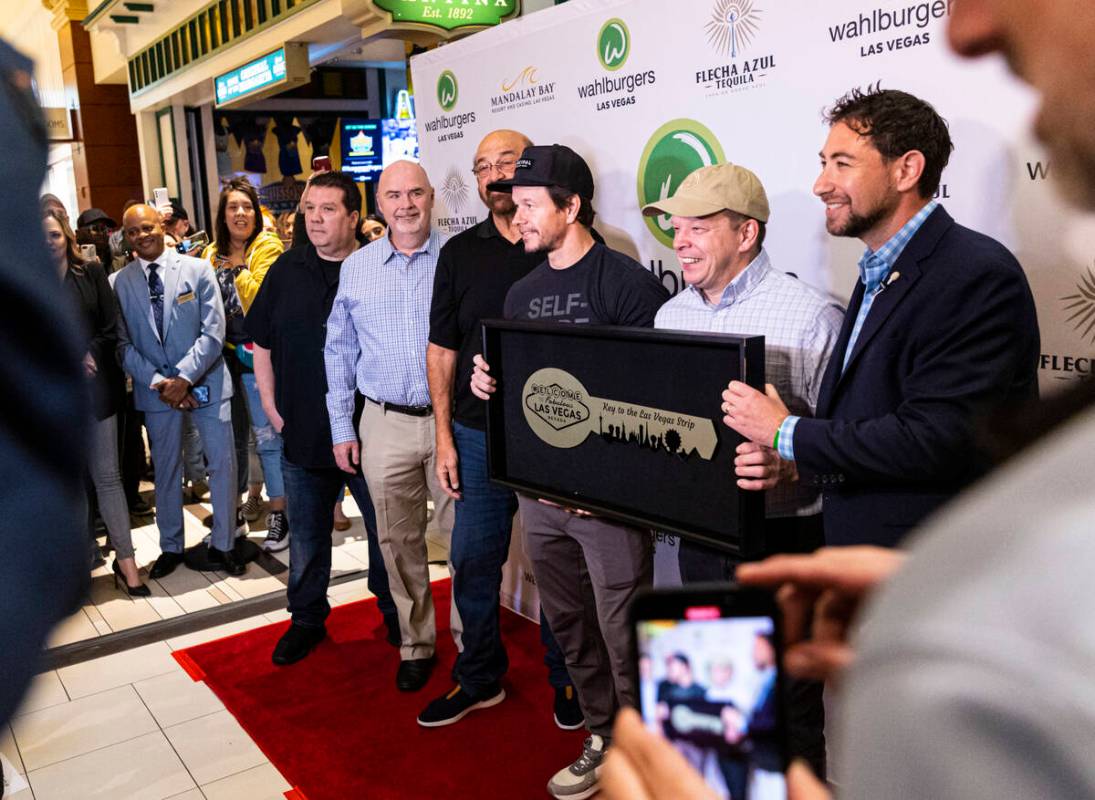 Clark County Commissioner Michael Naft, right, presents brothers Mark Wahlberg and Paul Wahlber ...