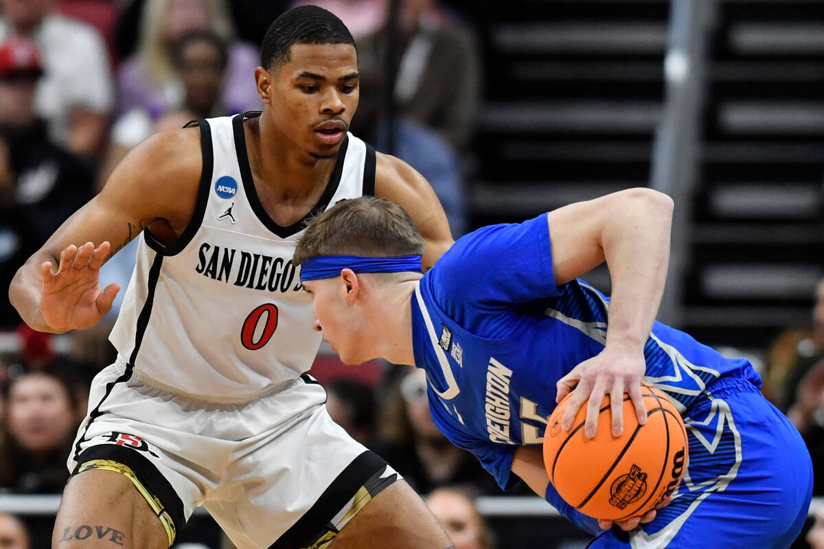 Creighton guard Baylor Scheierman (55) moves the ball against San Diego State forward Keshad Jo ...