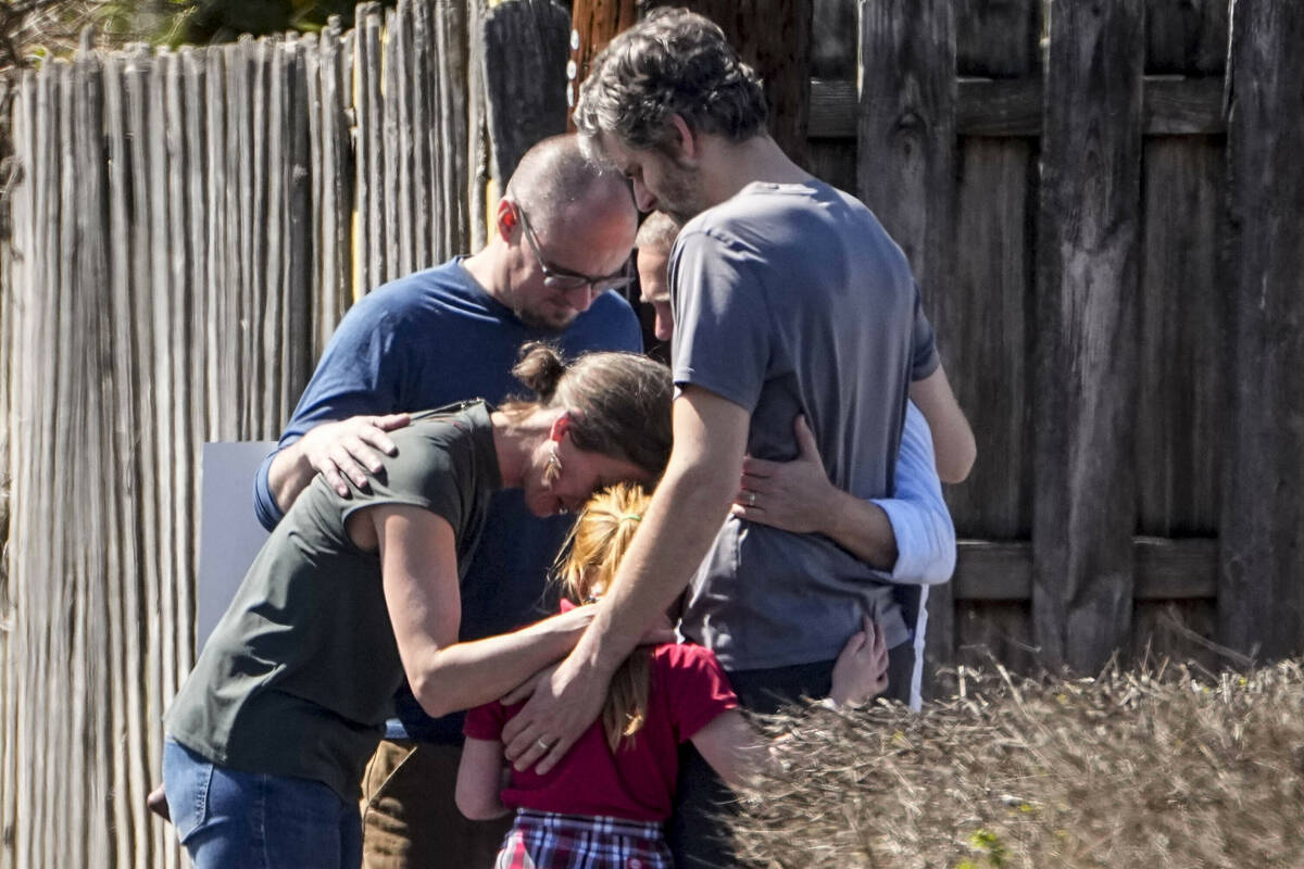 A group prays with a child outside the reunification center at the Woodmont Baptist church afte ...