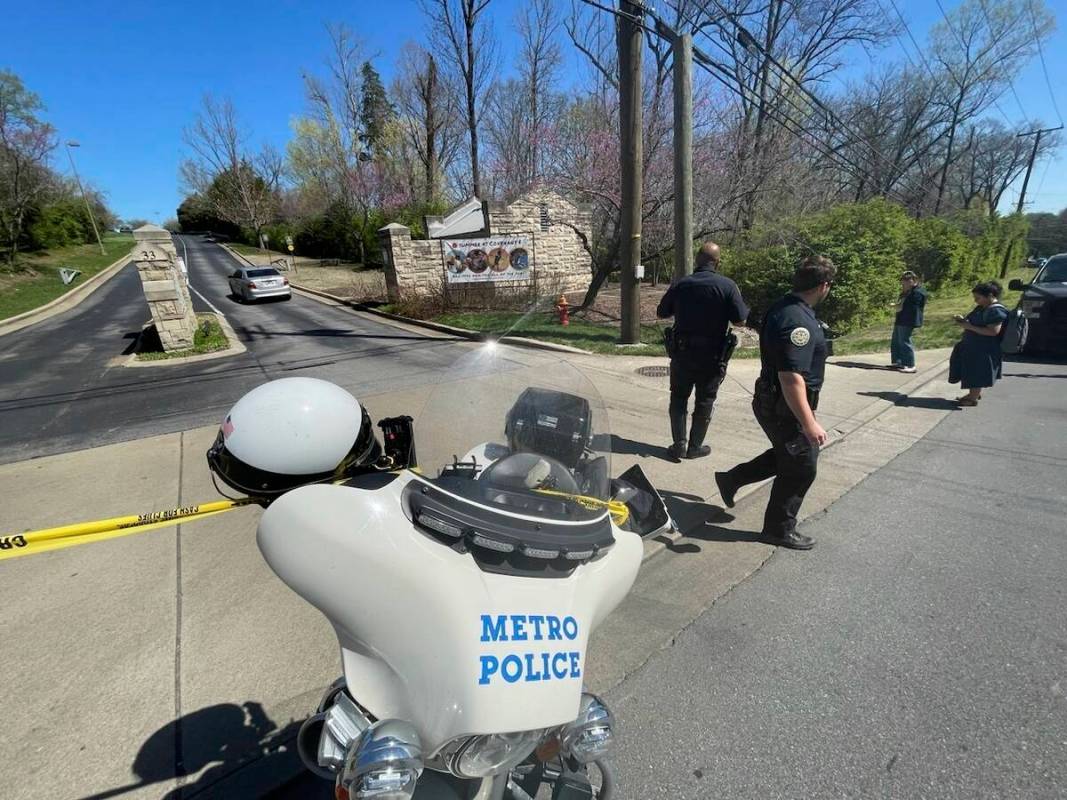 Metro Nashville Police Department officers walk outside of The Covenant School in Nashville, Te ...