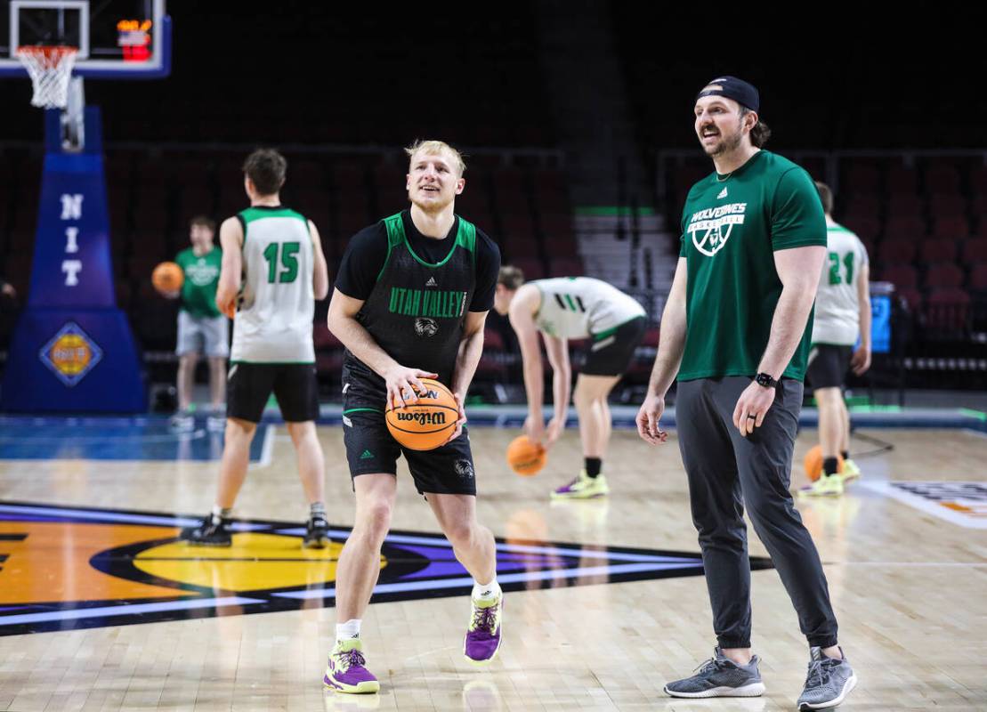 Utah Valley Wolverines player Trey Woodbury, left, chats with graduate assistant coach Truman M ...