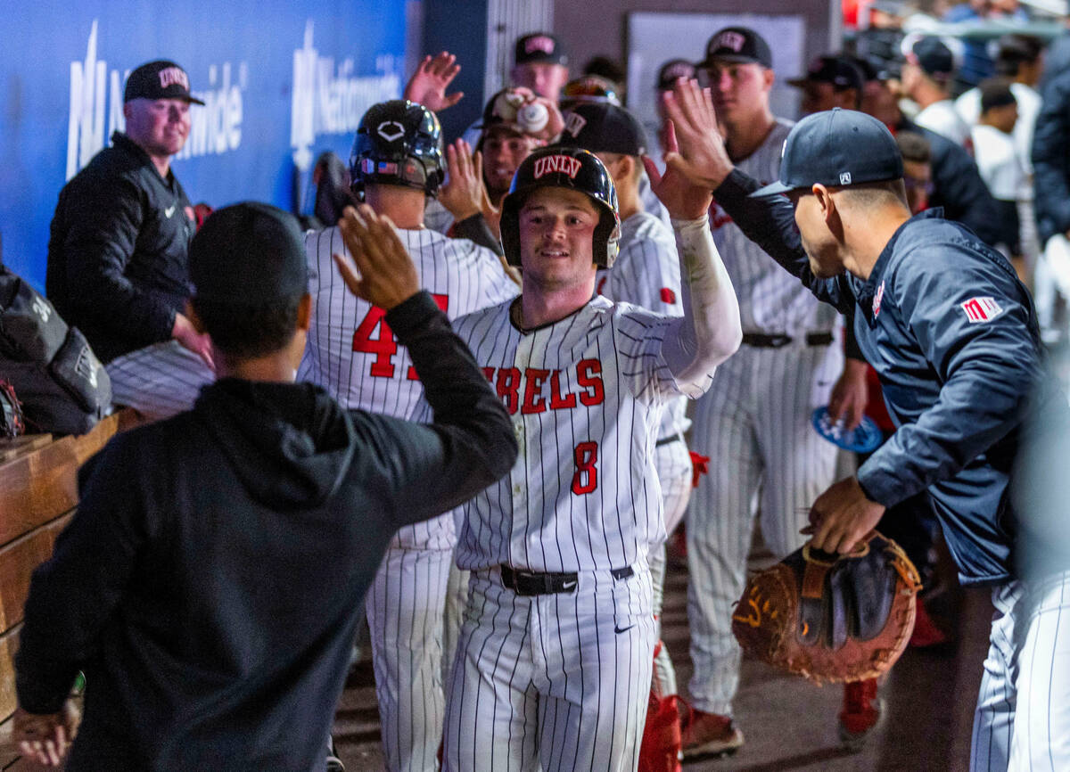 UNLV outfielder Santino Panaro (8) is congratulated on a run against Arizona State during the s ...