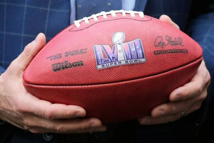 Gov. Joe Lombardo holds an NFL football with the Super Bowl LVIII logo in February 2023. (AP Ph ...