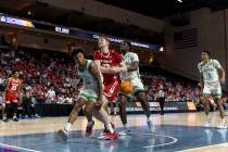 North Texas Mean Green guard Kai Huntsberry (10) knocks the ball away from Wisconsin Badgers fo ...