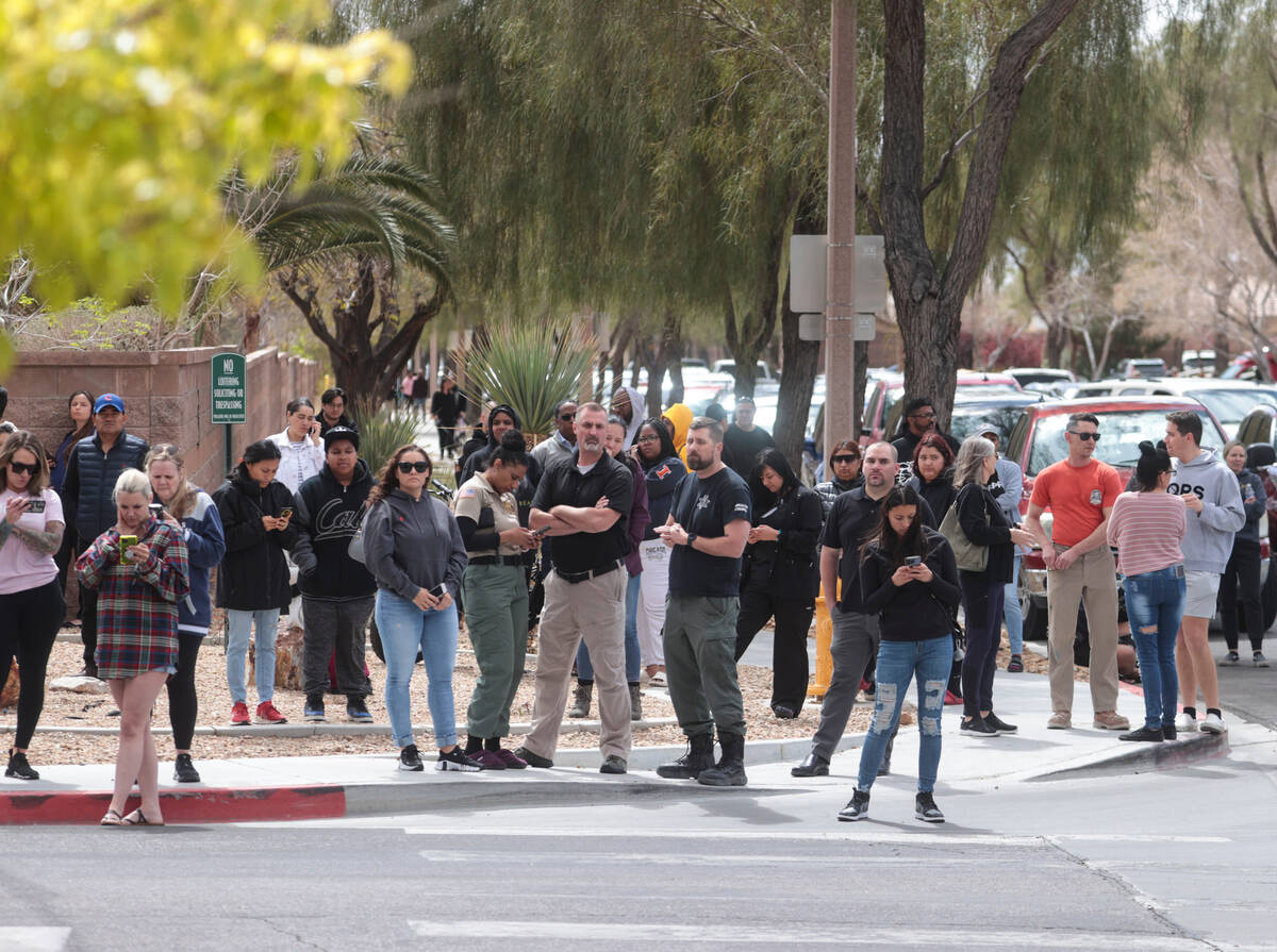 Parents wait outside of Shadow Ridge High School as Las Vegas police investigate after a threat ...