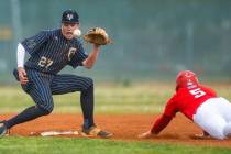 Spring Valley infielder Grant Kelly eyes a bouncing throw to second base as Liberty runner Domi ...