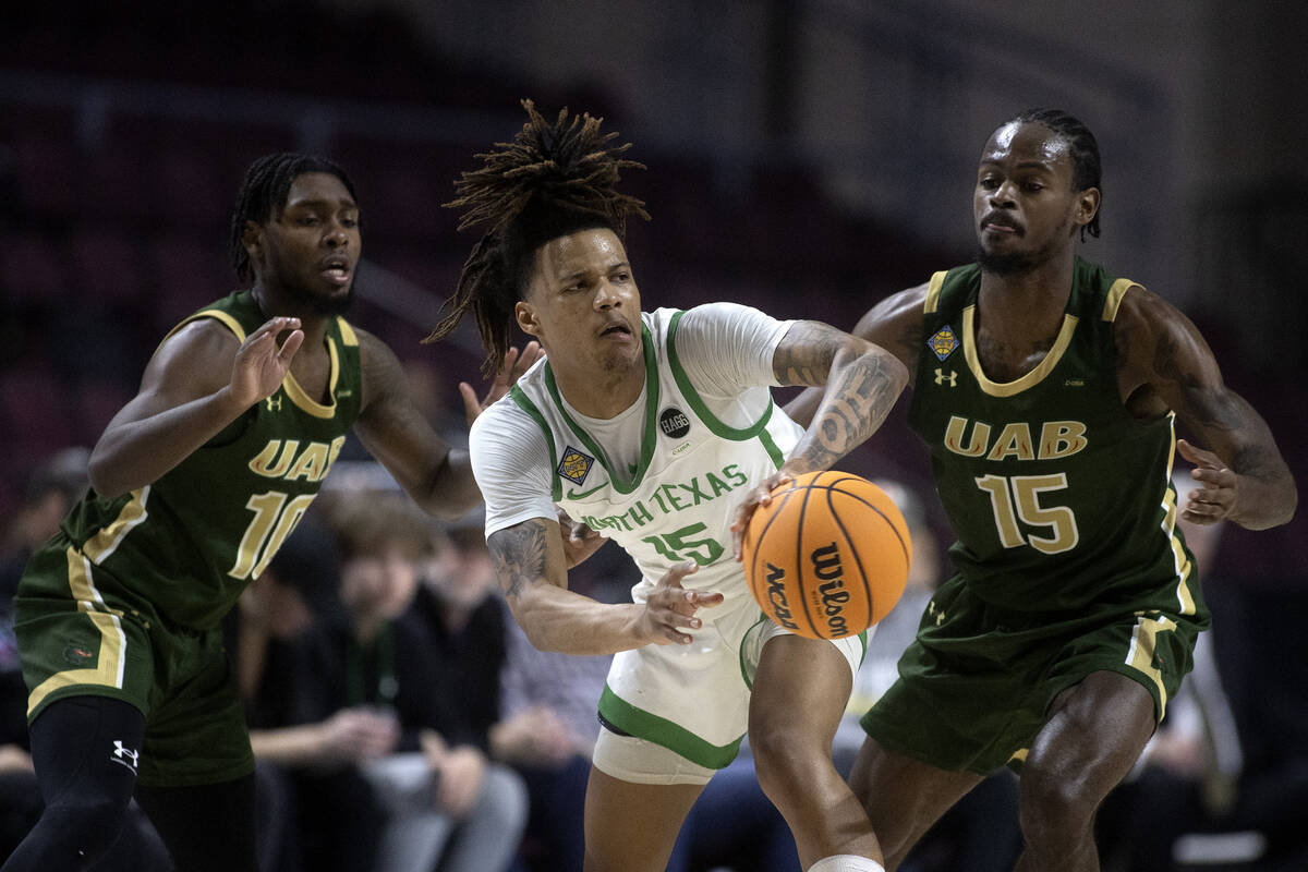 North Texas Mean Green guard Rubin Jones (15) pass while UAB Blazers guard Jordan Walker (10) a ...