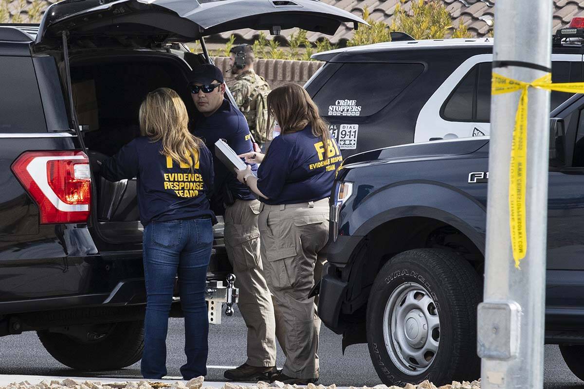 Members of the FBI's Evidence Support Team converse outside Matthew Beasley's home while negoti ...