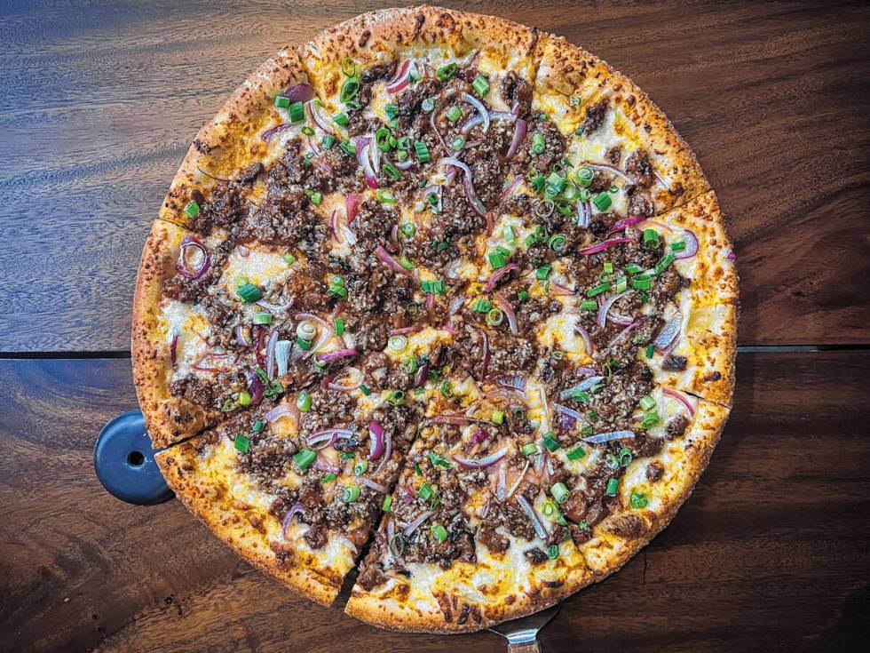 The limited-time brisket pizza from Crust & Roux in the Town Square center in Las Vegas fea ...