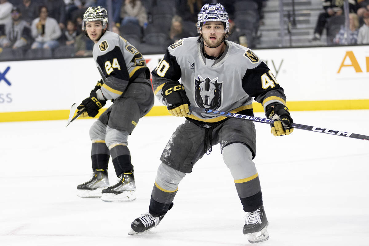 Henderson Silver Knights forward Brendan Brisson (24) defenseman Lukas Cormier (40) watch the p ...