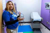 Pamela Girgis, a nurse practitioner, leads a tour of a free clinic inside Bailey Middle School, ...