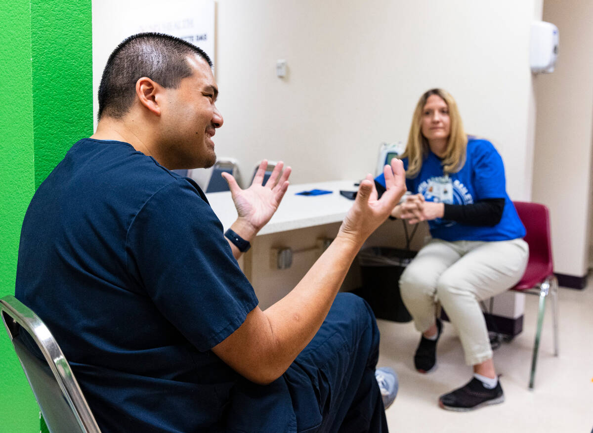 Dr. Julpohng Vilai, left, a pediatrician, speaks during an interview with the Review-Journal as ...