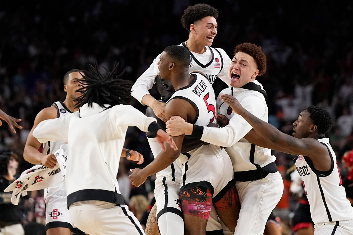 San Diego State guard Lamont Butler (5) celebrates with teammates after scoring the winning bas ...