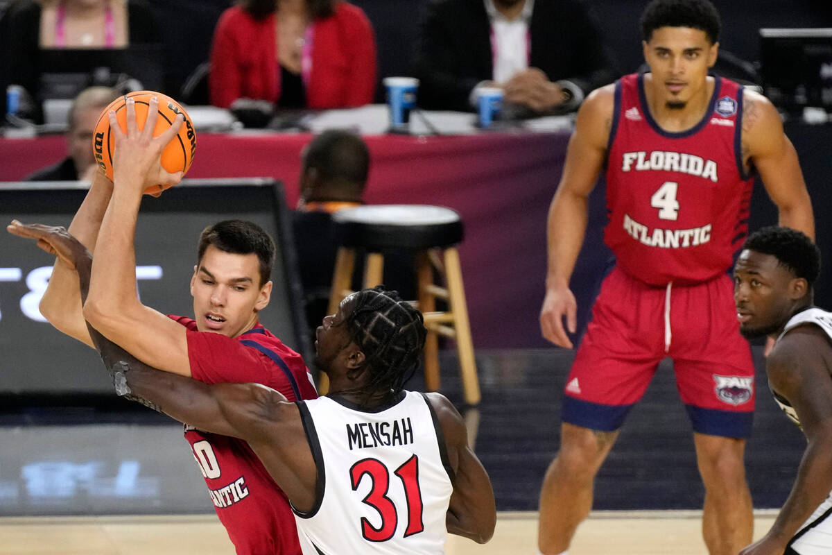 Florida Atlantic center Vladislav Goldin (50) is pressured by San Diego State forward Nathan Me ...