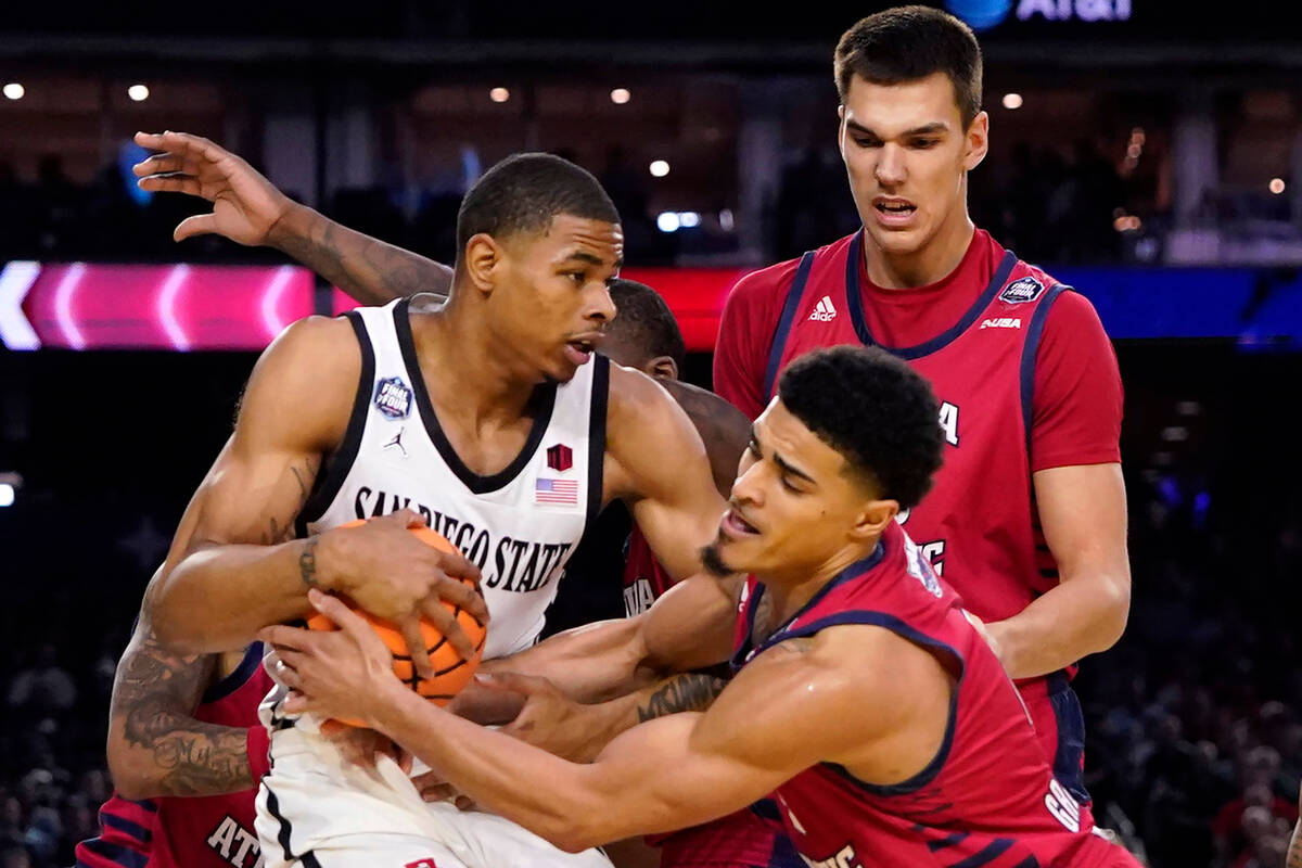 San Diego State forward Keshad Johnson, left, and Florida Atlantic guard Bryan Greenlee, right, ...