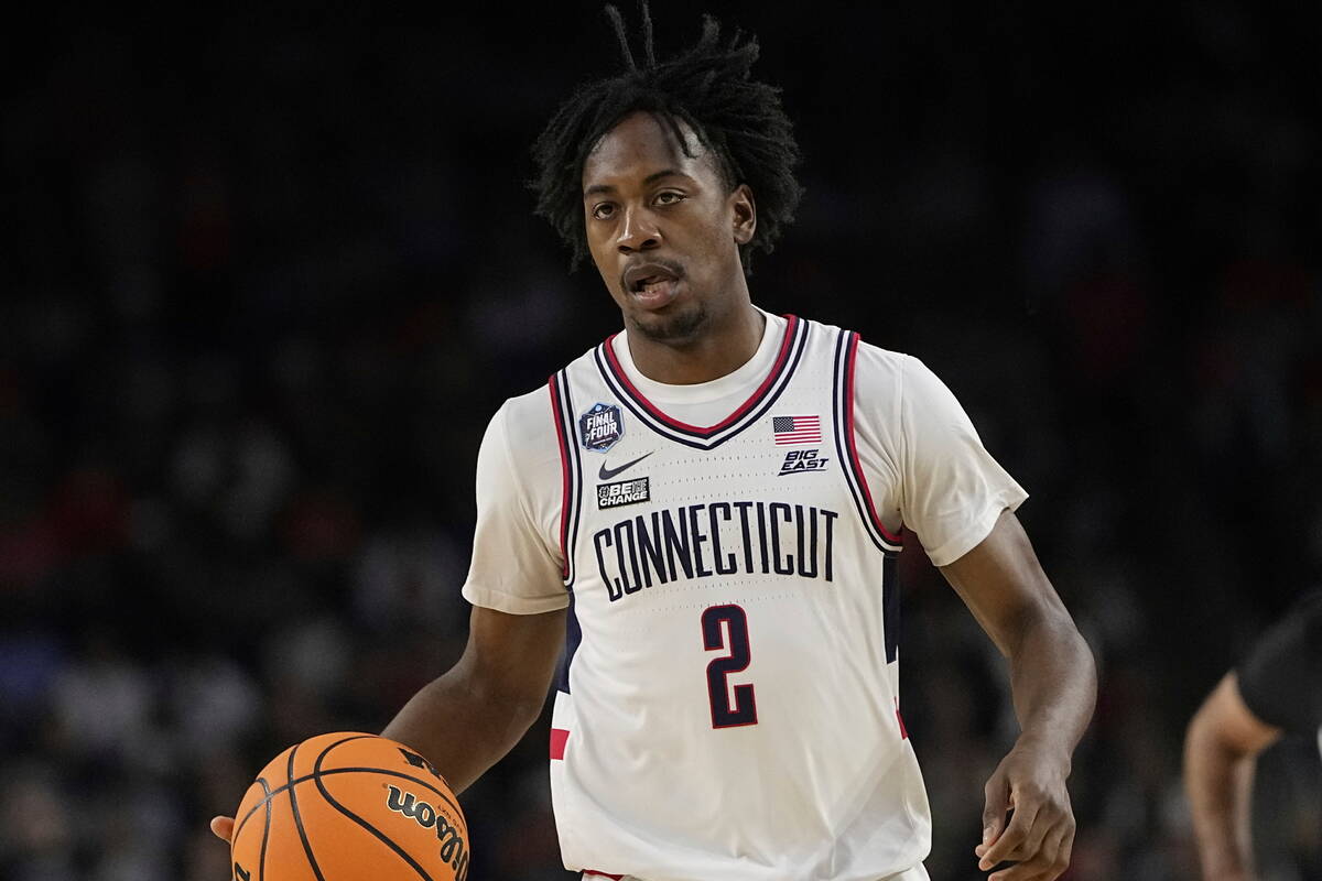 Connecticut guard Tristen Newton brings the ball down court against Miami during the first half ...