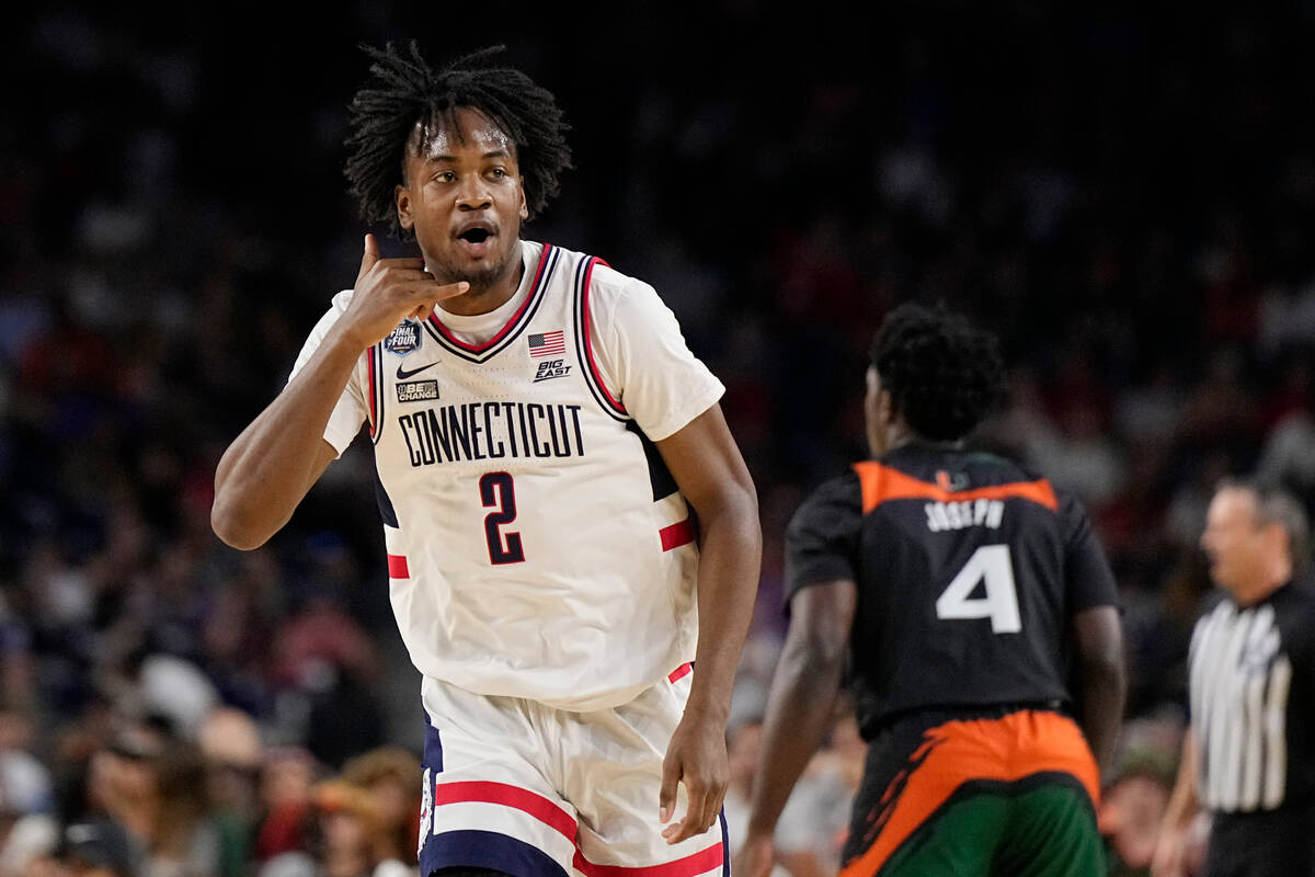 Connecticut guard Tristen Newton celebrates after scoring against Miami during the first half o ...