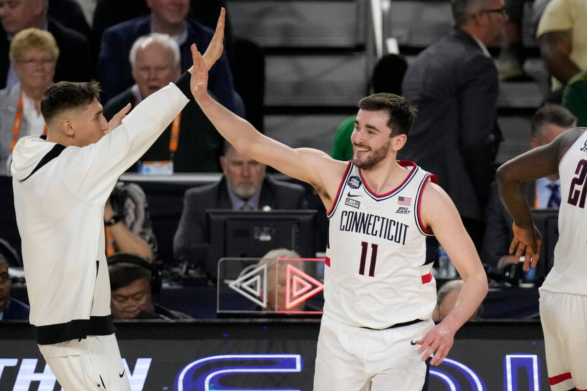 Connecticut forward Alex Karaban (11) celebrates a score with a teammate during the first half ...