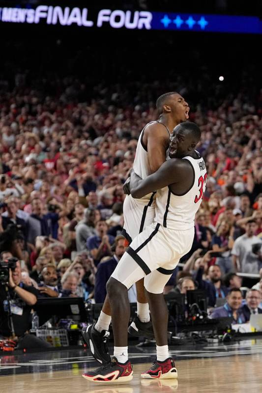 San Diego State guard Lamont Butler, left, celebrates after scoring the game winning basket wit ...