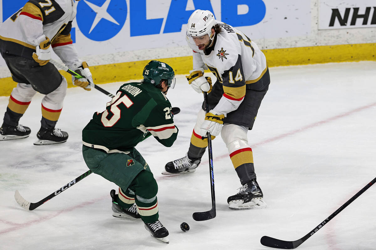 Vegas Golden Knights defenseman Nicolas Hague (14) handles the puck against Minnesota Wild defe ...