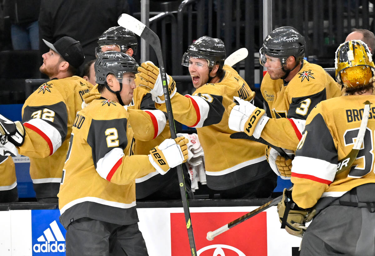 Vegas Golden Knights defenseman Zach Whitecloud (2) celebrates with the defenseman Ben Hutton ( ...