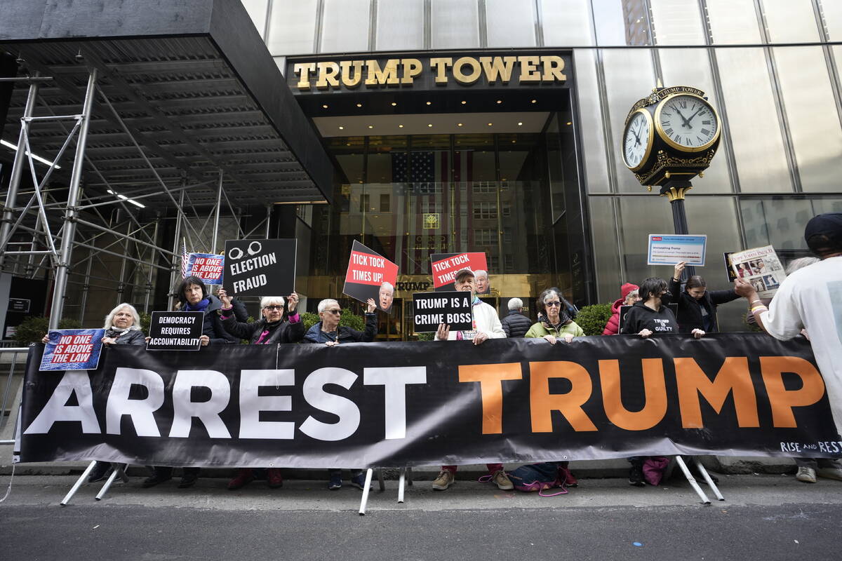 FILE - Protesters gather outside Trump Tower on Friday, March 31, 2023, in New York. Former Pre ...