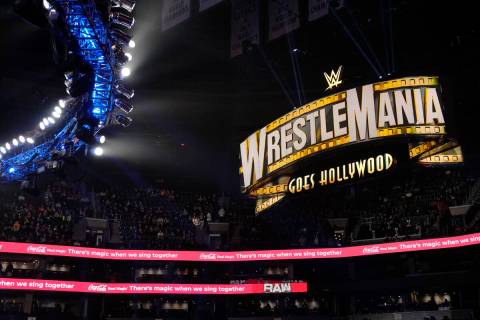 A WrestleMania sign hangs over the crowd during the WWE Monday Night RAW event, Monday, March 6 ...