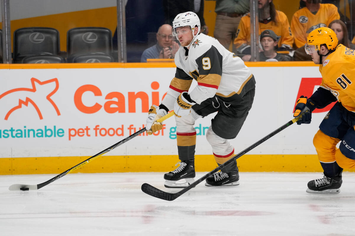 Vegas Golden Knights center Jack Eichel (9) skates the puck past Nashville Predators defenseman ...