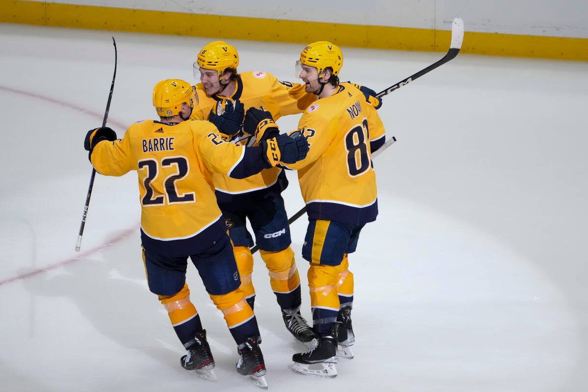 Nashville Predators defenseman Tyson Barrie (22) and center Tommy Novak (82) congratulate cente ...