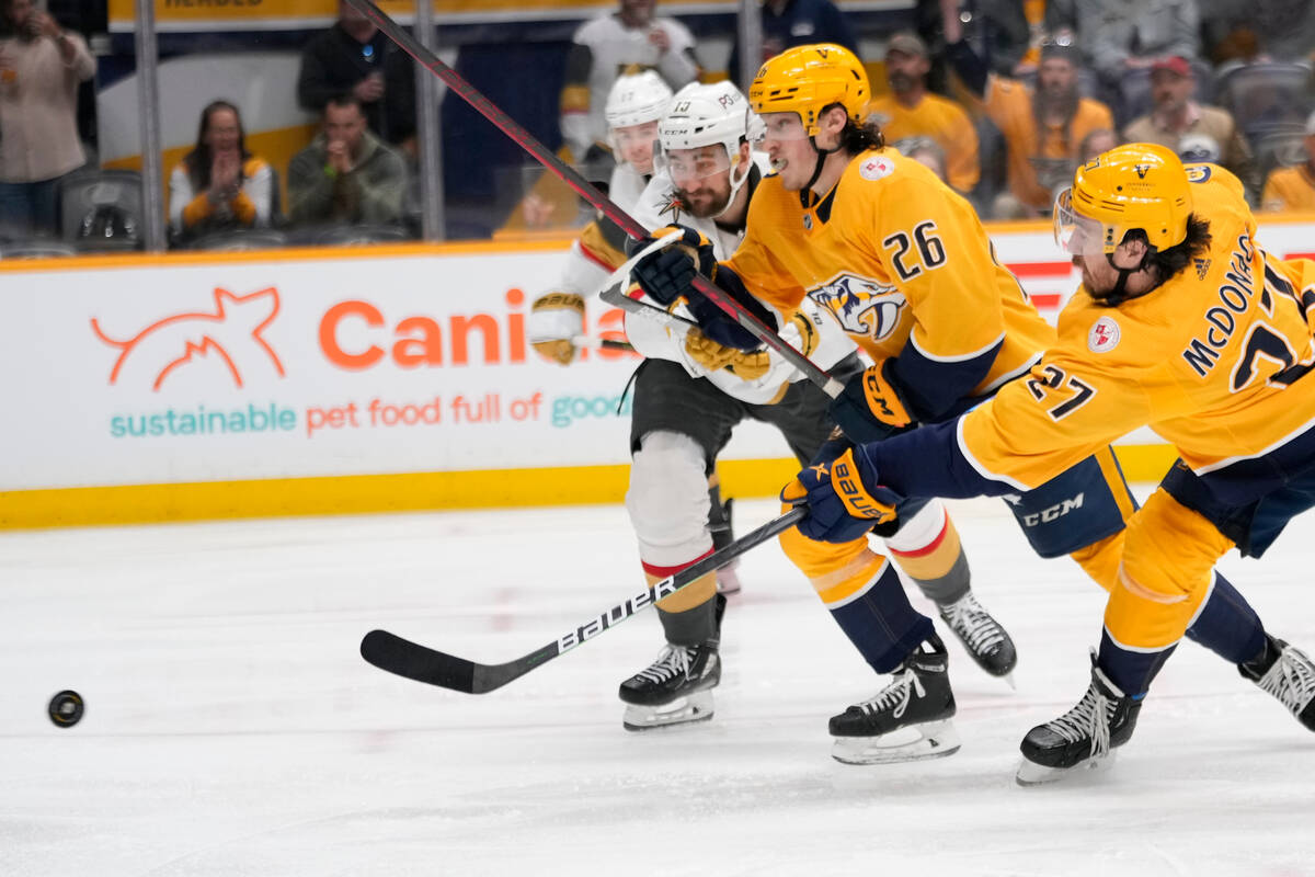 Nashville Predators defenseman Ryan McDonagh (27) shoots past teammate center Philip Tomasino ( ...