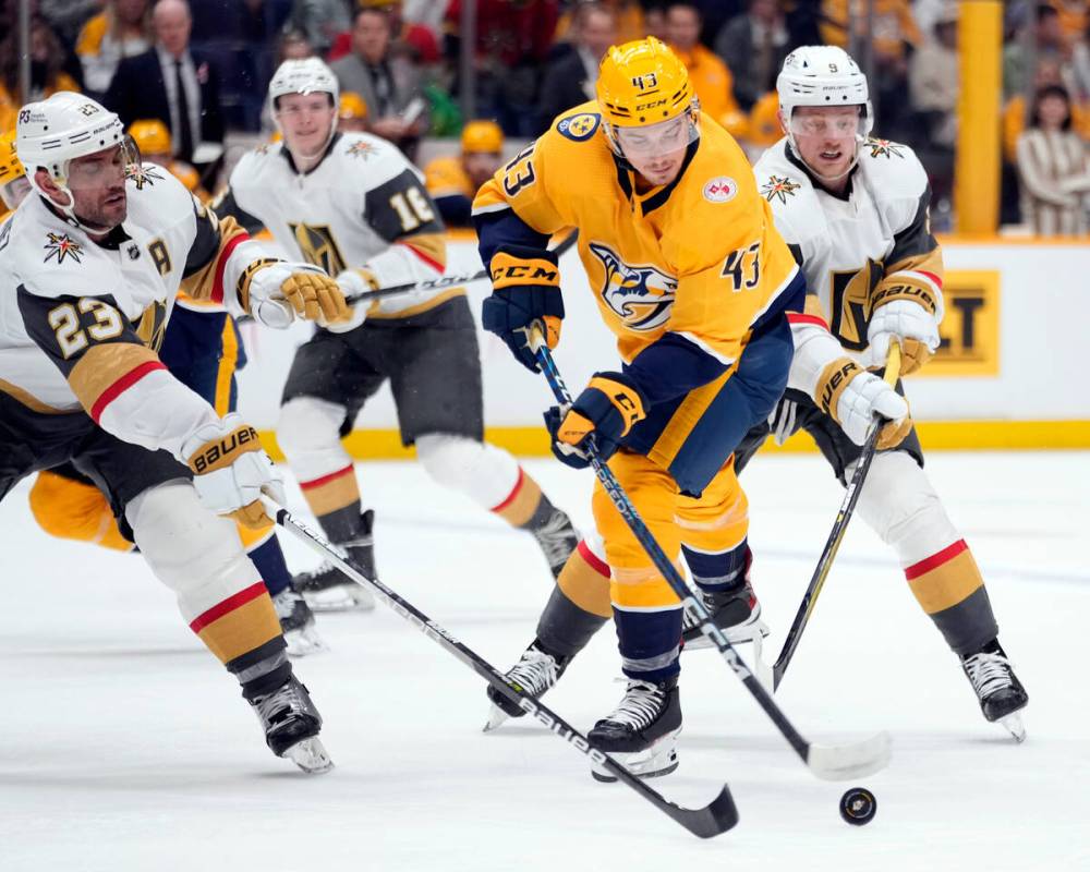 Nashville Predators left wing John Leonard (43) skates the puck past Vegas Golden Knights defen ...