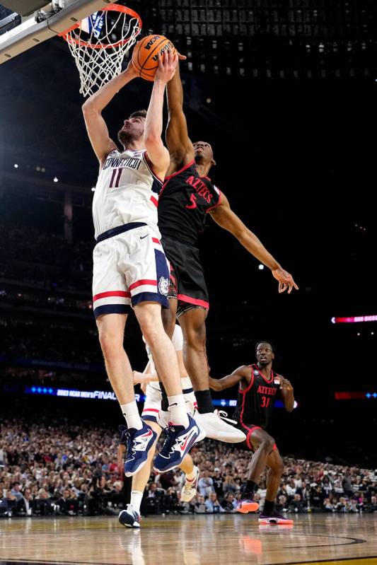 San Diego State guard Lamont Butler blocks a shot by Connecticut forward Alex Karaban (11) duri ...