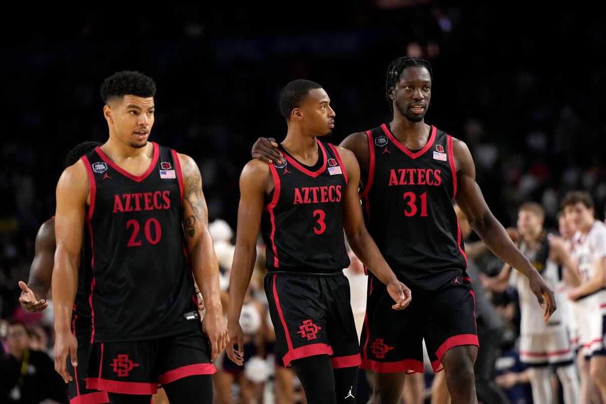 San Diego State guard Matt Bradley (20), guard Micah Parrish (3) and forward Nathan Mensah (31) ...