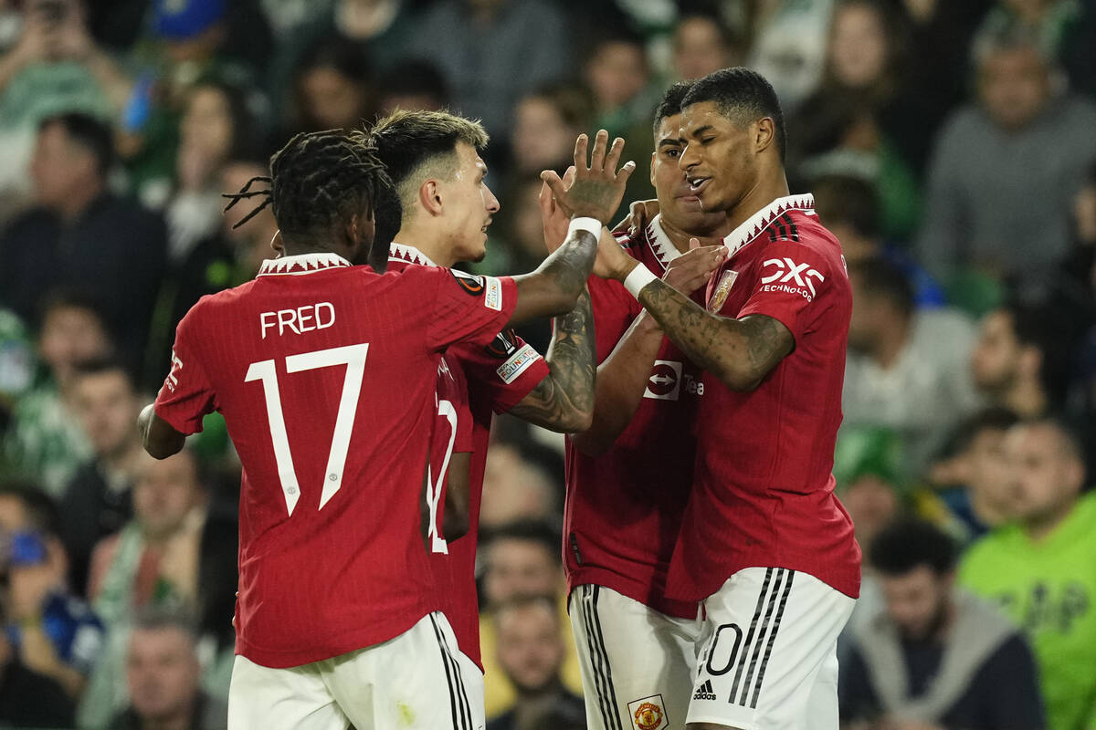 Manchester United's Marcus Rashford, right, celebrates after scoring his side's first goal duri ...