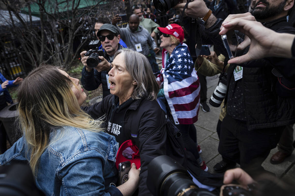 Protesters argue at the Collect Pond Park across the street from the Manhattan District Attorne ...