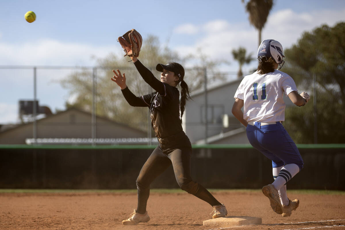 Faith Lutheran’s Ava Koenig reaches to catch while Green Valley’s Avari Morris ma ...