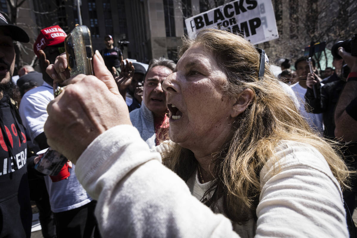 People argue about politics at a protest held at Collect Pond Park, Tuesday, April 4, 2023, acr ...