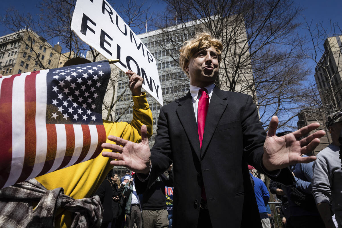 A Donald Trump impersonator appears at a protest held in Collect Pond Park, Tuesday, April 4, 2 ...