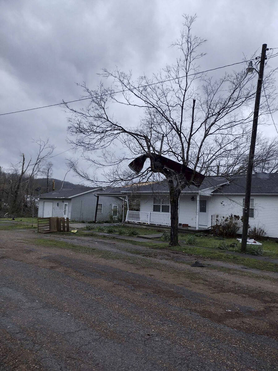 Debris covers the ground as homes are damaged after severe weather in Glen Allen, Mo., on Wedne ...