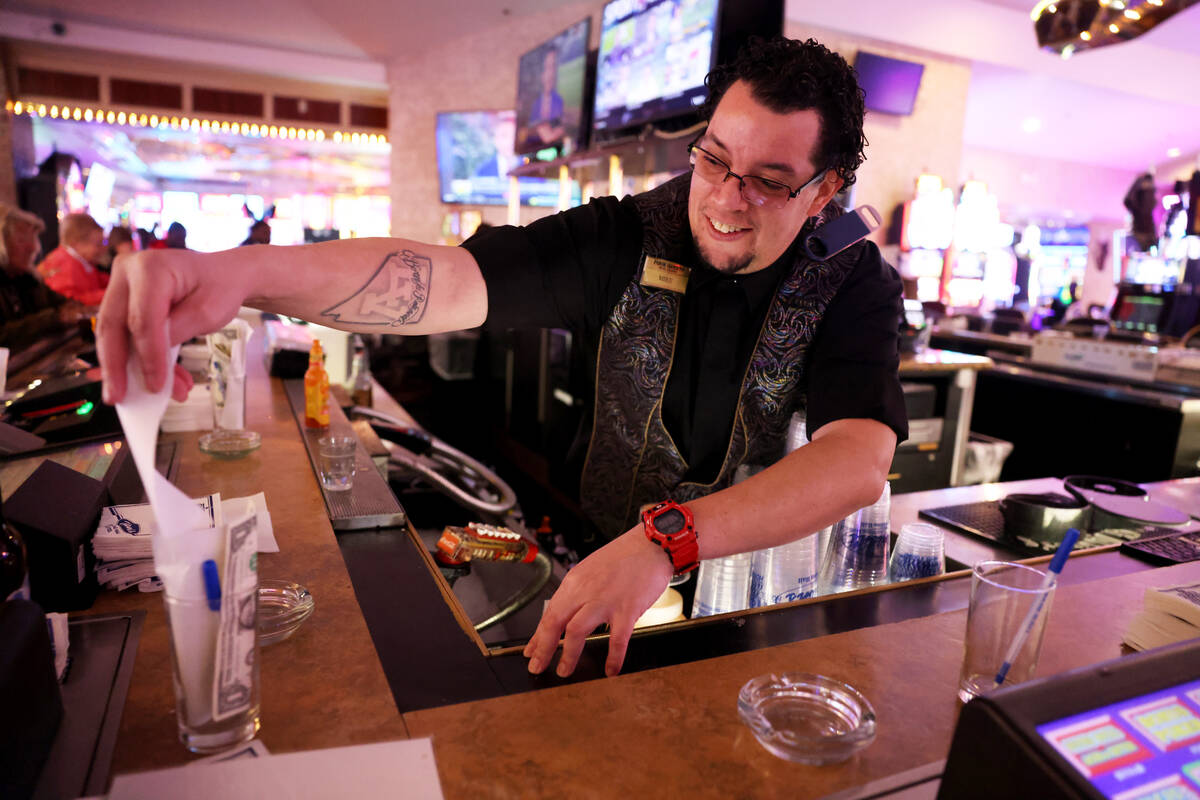 Bartender Michael Wood updates a customer’s tab at the Four Queens in downtown Las Vegas ...