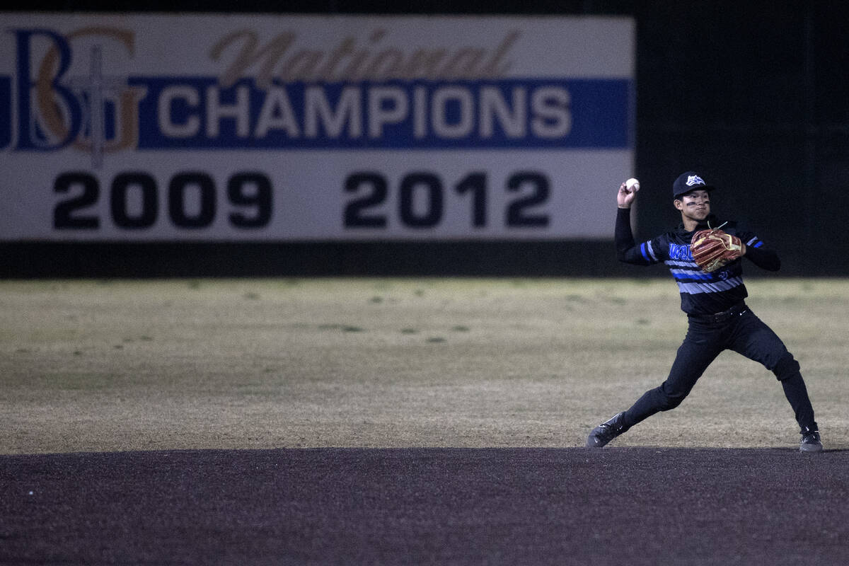 Basic outfielder Nathan Vigil throws to first base for an out during a high school baseball cha ...