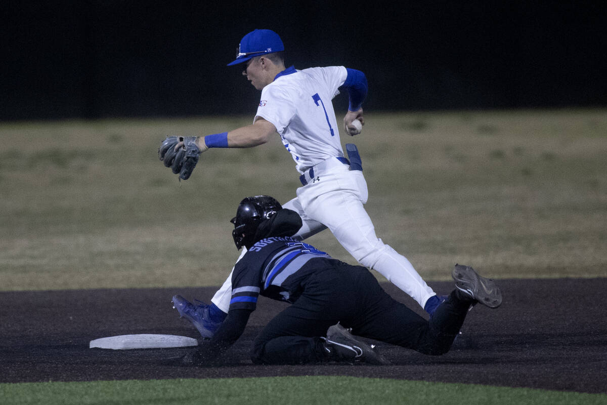 Basic’s Ty Southisene slides into second base while Bishop Gorman’s Colton Boardm ...