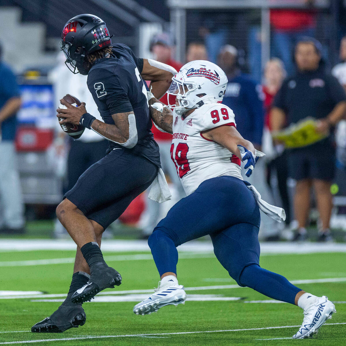 UNLV Rebels quarterback Doug Brumfield (2) spins away from a sack attempt by Fresno State Bulld ...