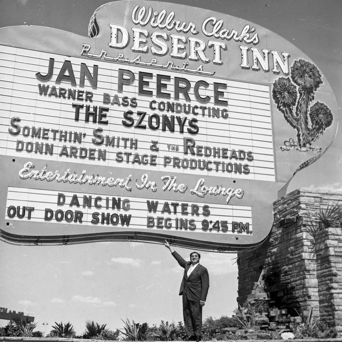 Wilbur Clark points out the Desert Inn marquee, featuring Jan Peerce, in Las Vegas on September ...