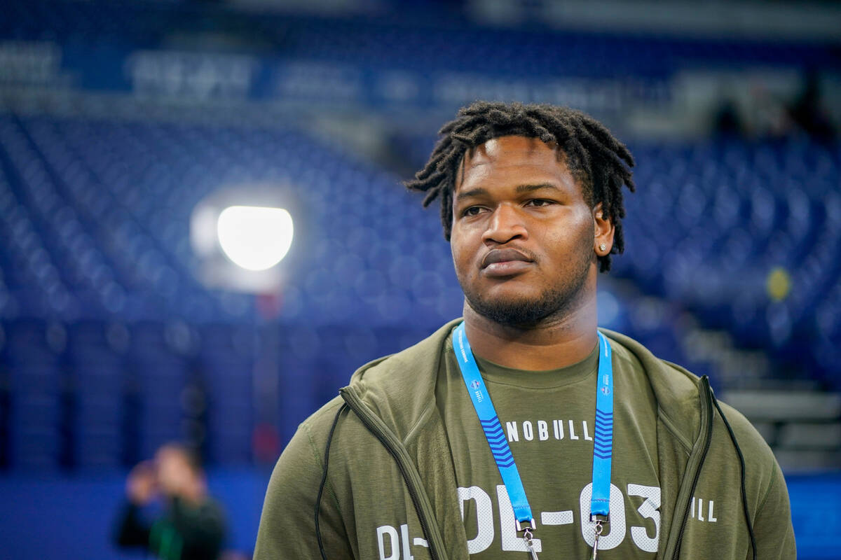 Georgia defensive lineman Jalen Carter watches as players warm up on the field before the NFL f ...