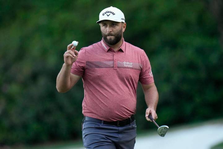 Jon Rahm, of Spain, waves after his putt on the 13th hole during the final round of the Masters ...