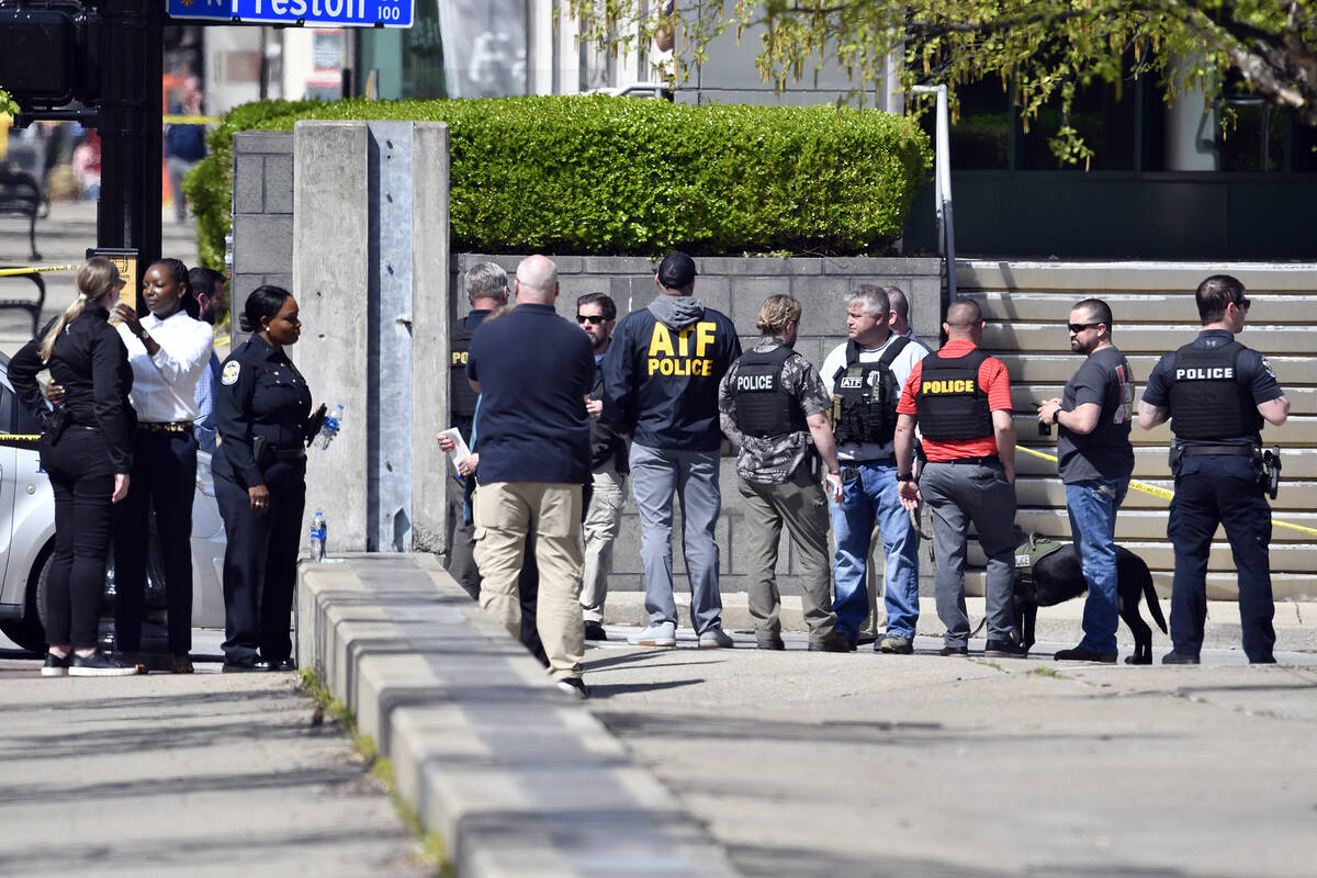 Members of theLouisville Metro Police and federal ATF agents gather outside of the Old National ...