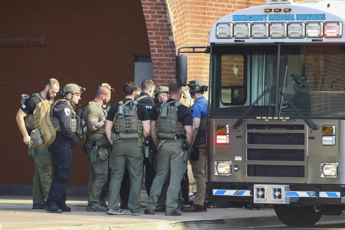 Multiple agencies arrive at a building after a shooting took place in Louisville, Ky., Monday, ...