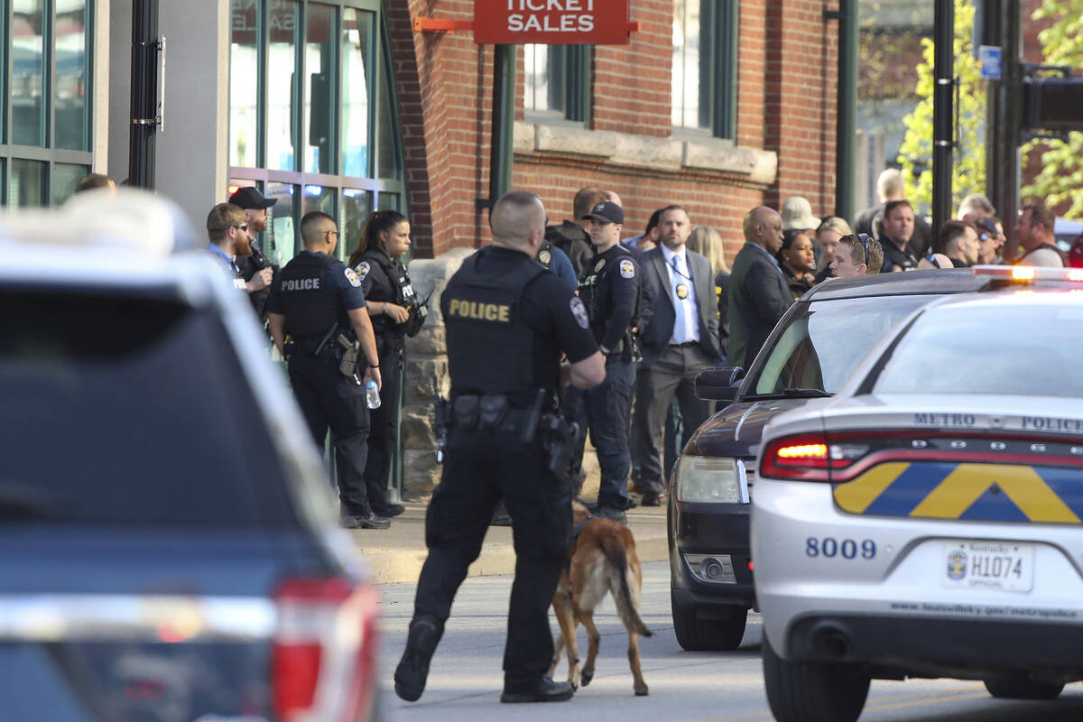 Multiple agencies arrive at a building after a shooting took place in Louisville, Ky., Monday, ...